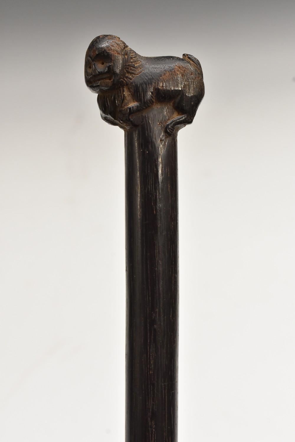 A tribal walking stick, the pommel carved as a stylised baboon, 88cm long,