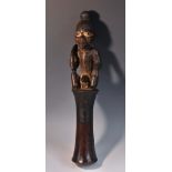 Tribal Art - an African pestle, carved with a seated figure holding an oliphant, 39.