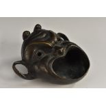 A 19th century Italian Grand Tour patinated bronze oil lamp, cast a grotesque mask,