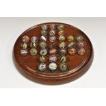 A Victorian mahogany circular solitaire board,