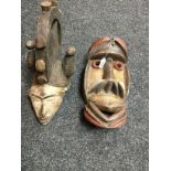 Tribal Art - An African Agbogbo Mmuo softwood mask, picked out in earth pigments, 42cm long ,