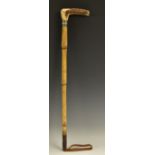 An early 20th century silver coloured metal mounted riding crop, L-shaped stag antler handle,