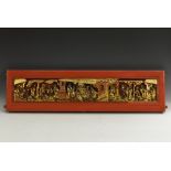 A Chinese polychrome and gilt softwood rectangular pagoda panel, carved with a frieze of figures,