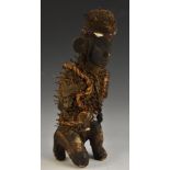 Tribal Art - an African nkondi nail fetish figure, adorned with cowrie shells and fibres, 31cm high,