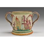 A 19th century English pottery loving cup, moulded in relief with a Punch and Judy show,
