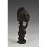 Tribal Art - an African figure, standing, with stylised coiffure and scarified features,