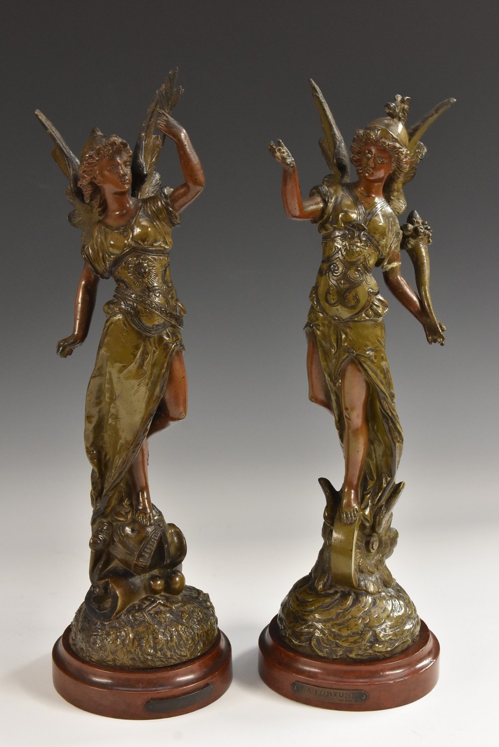 A pair of late 19th century French brown patinated spelter sculptures of La Paix and La Fortune,