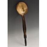 A 19th century horn spoon or ladle, the handle carved with a mask, 30.