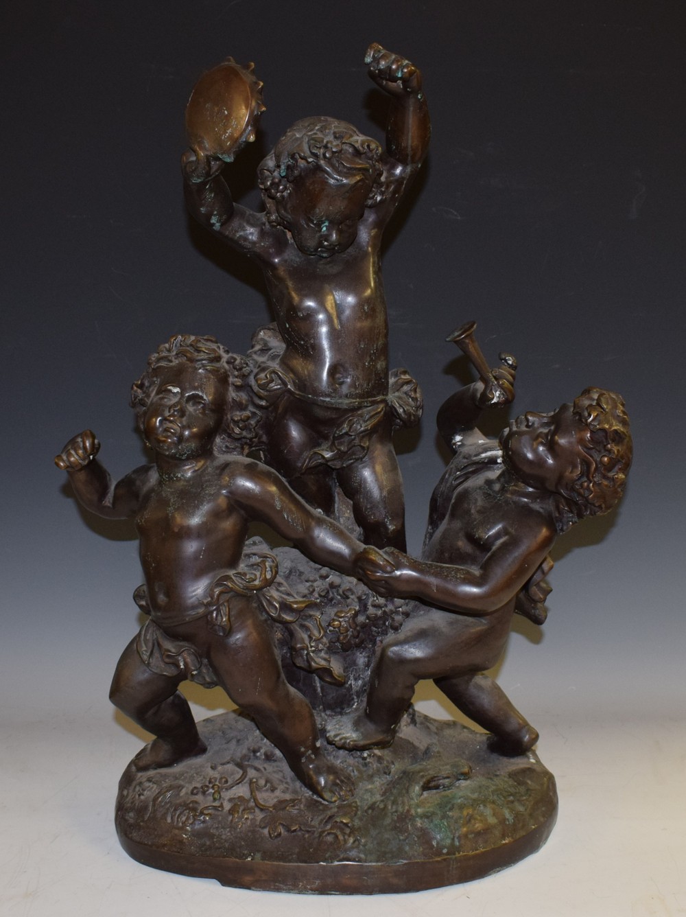 French School, a substantial dark patinated bronze, of revelling Bacchic putti, traces of verdigris,