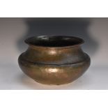 A Middle Eastern bronzed flared bowl, chased with Islamic calligraphy, foliage and motifs,