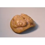 A Chinese hardstone toggle or amulet, carved in relief with stylised rams' heads, 5.