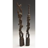 Tribal Art - an Oceanic hardwood figure, she stands, holding an offering,