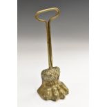 A Regency bronze door stop, cast as a lion's paw, posted loop handle, lead-weighted, 31.5cm high, c.