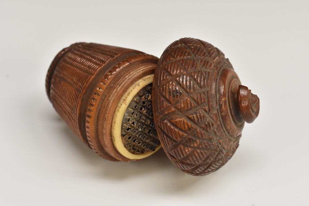 A 19th century coquilla nutmeg grater, screw-fitting cover enclosing a steel rasp, 6.5cm long, c.