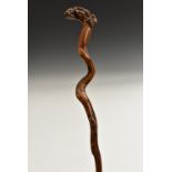 A 19th century fruitwood folk art walking stick, the handle carved with a snake and fruiting vine,