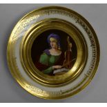 A French porcelain circular cabinet plate, painted in polychrome with St Cecilia, gilt borders,