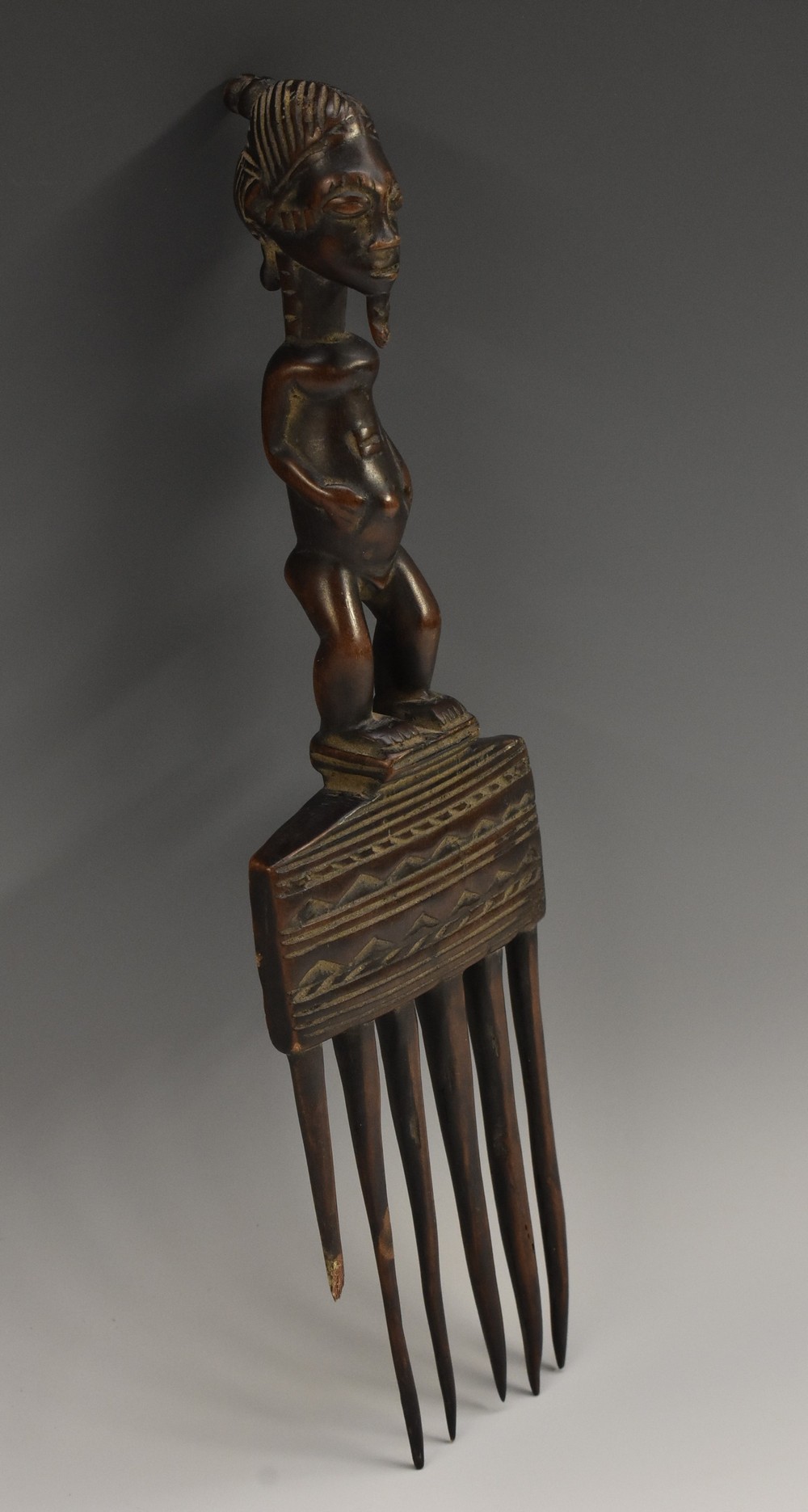 Tribal Art - a Luba comb, figural handle, chip-carved geometric frieze, 29cm long,