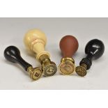 A collection of 19th century desk seals, various matrices and handles, faux ivory, ebony,