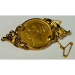 A Victorian full sovereign brooch, floral mount, London Mint 1882, 9ct gold mount, 13.