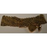A late 19th/early 20th century yellow metal thirteen row gate bracelet, unmarked,
