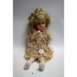 A 19th century style wax doll, blue glass eyes, open mouth, red lips, long blond curly hair,