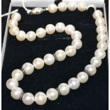 A cultured pearl and diamond beaded necklace, front section of creamy white cultured pearls,