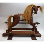 A small table-top rocking horse, pivoting frame,