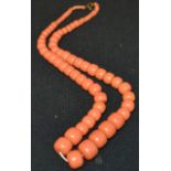 A simulated pale pink coral graduating barrel bead necklace,