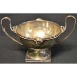 A silver two handled pedestal cup, four classical masks to rim, Sheffield 1938, 6.