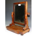 A 19th century Georgian/early Victorian mahogany mirror, pitted plate, shaped arms, serpentine base,