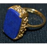 A lapis lazuli rectangular seal stamp panel ring, plain matrix, pierced basket collar,