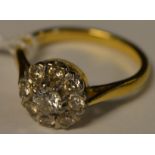 A diamond cluster ring, central round brilliant cut diamond approx 0.