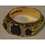 A diamond and deep blue black sapphire ring, later in fitted with a 9ct gold wedding band, 7.