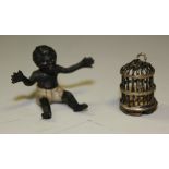 An early 20th century miniature Austrian cold painted metal model, seated young child,