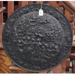 A painted cast iron circular wall plaque/roundel,
