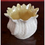 A Belleek swirling shell vase, lustre interior,