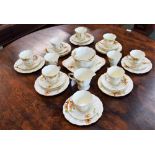 A Tuscan China Plant pattern part tea service, floral design ivory ground comprising cups, saucers,