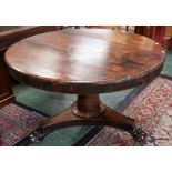 A 19th century rosewood centre table, circular top above a deep frieze,