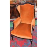 An Edwardian mahogany wing back armchair, c.