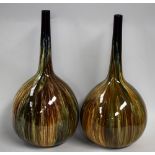 A pair of Bretby Art Pottery onion shaped bottle vases, drip glazed in mottled shades of green,