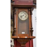 A mahogany Vienna eight day wall clock, enamelled dial, Roman numerals, subsidiary seconds track,