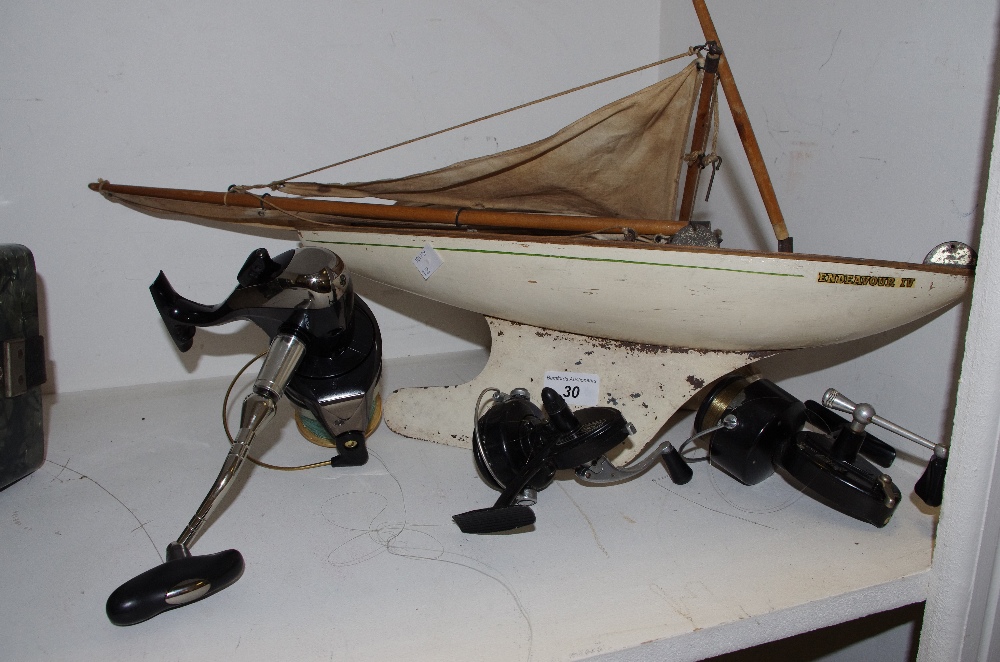 A scratch built yacht model of Endeavour IV; a Geologic FD65-7 fishing reel;