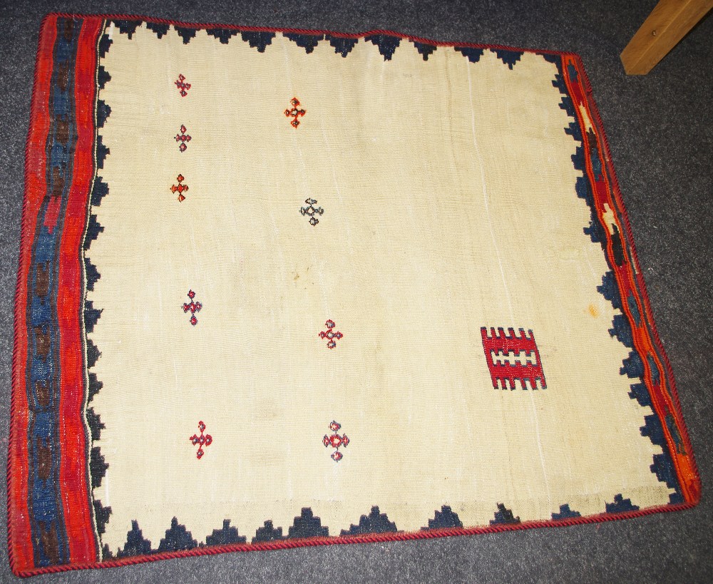 A hand woven Kilim Sofreh throw rug, in hues of burnt sienna,