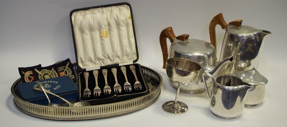 A white coloured metal Tennis trophy; A Picquot ware setting;