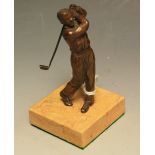 An early 20th century brown patinated bronze cabinet model, of a golfer taking a swing,