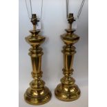 A pair of brass coloured table lamps, hexagonal shoulders, tapered stems,