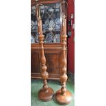 A pair of oak standard lamps, turned supports, circular bases,