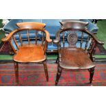 An elm bow elbow chair, curved cresting rail, the central splat applied with a radiating roundel,