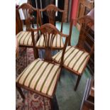 A set of four Hepplewhite style dining chairs