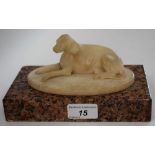 French School (19th century), an alabaster carving, of a recumbent dog, rectangular granite base,